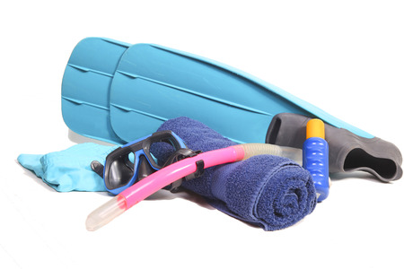 Flippers, snorkel, towel, suntan lotion and a swimsuit on whiteの写真素材