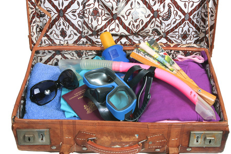 Vintage open suitcase with clothes and summer and beach  itemsの写真素材