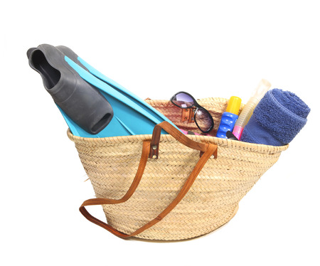 Vacation items in a wicker bagの写真素材