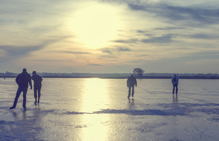 Ice skating on a frozen lake in the Netherlandsの写真素材