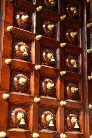 Hindu temple door with lots of bellsの写真素材