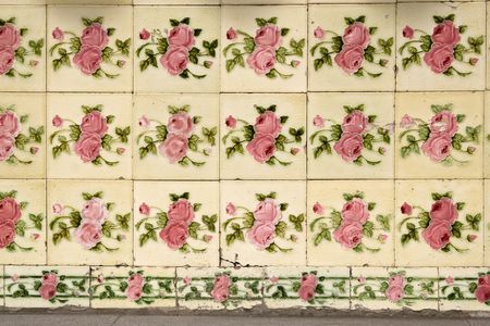 Close up old wall tiles with roses on it in Singapore.