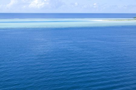 A far shoot of a beach with blue reef in a island resort in maldives.の写真素材