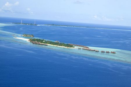 A top view of a island resort with villa in maldivesの写真素材