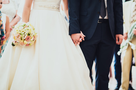 bride and groom holding their handsの写真素材