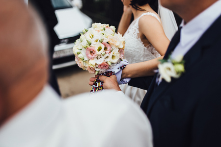 bride and groom with bouquet of flowersの写真素材