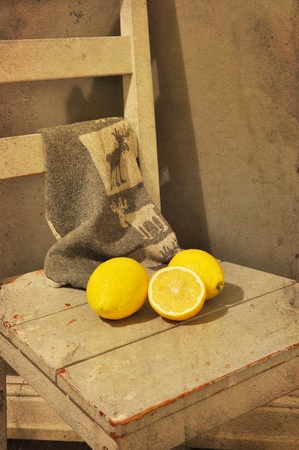 Three lemons on a chair. Vintage look.の写真素材