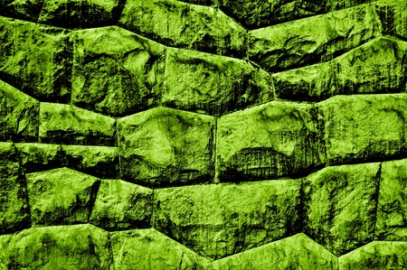 Green, rough old stone wallの写真素材