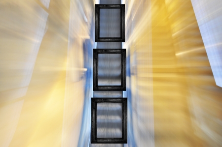Three black frames in different sizes on blured escalator background.の写真素材