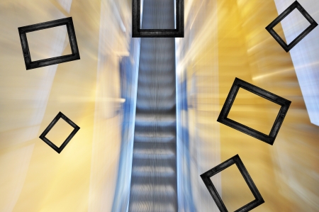 Black frames scatter from blurred escalator background.の写真素材