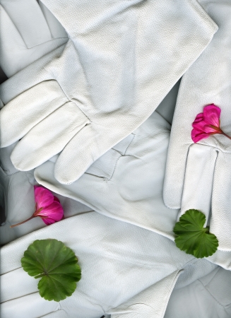 A pile of gardening gloves with pink flowers and green leaves.の写真素材