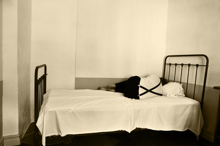 Depressed man on bed in a mental hospital の写真素材