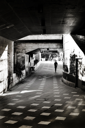 Person walking in urban morning.の写真素材