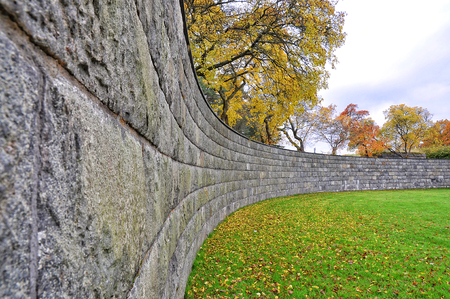 Curved stone wall in fallの写真素材