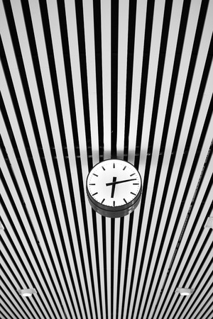 Clock with graphic lined ceiling as background