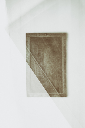 Artistic, creative image of simple board on a wall, partly blurred.の写真素材