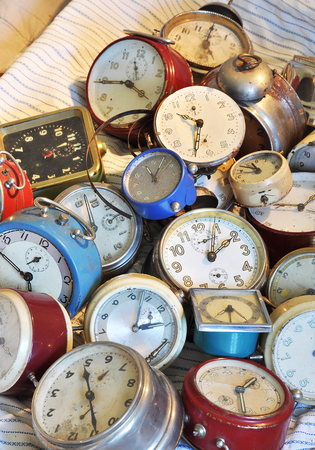 A pile of old retro alarm clockの写真素材