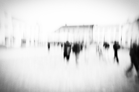 High key textured blurred image of people moving across a square in the city.の写真素材