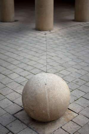 Closeup of round stone with pillars in the backgroundの写真素材