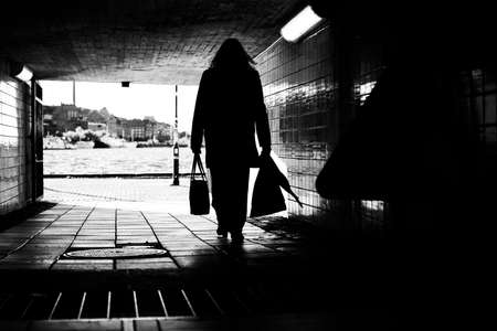 Silhouette of unrecognizable business woman exiting the subway.の写真素材