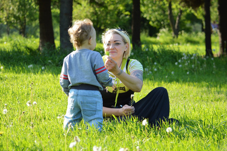 Mother and son walking in the park.の写真素材