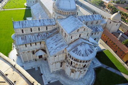 Pisa cathedral and Pisa tower close to it in one cloudy day, Italyの写真素材