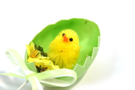 yellow toy easter chick hatching out of an egg shell