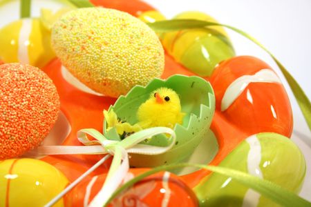 Egg shaped dish holding colorful Easter eggs