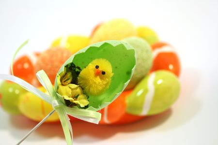 Egg shaped dish holding colorful Easter eggs