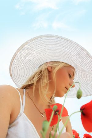 Beautiful girl in the poppy fieldの写真素材