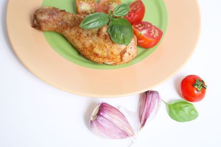 roasted chicken legs with tomato and herbsの写真素材