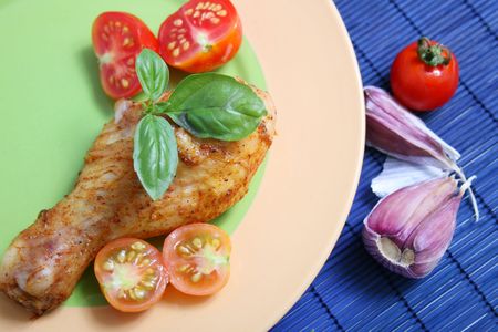 roasted chicken legs with tomato and herbsの写真素材