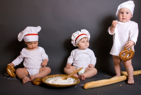 three  Cute little boy in a suit of Food Boy with kitchen accessories. In the studioの写真素材