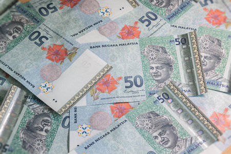 A big pile of Malaysian Ringgit. A large amount of 50 ringgit banknotes. Wildly jumbled bunch...
