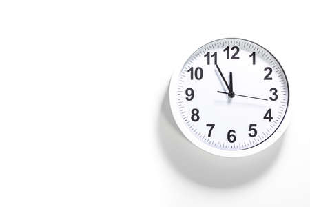 A classic wall clock show the time. It's close to 12 o'clock. The latest report of the atomic scientist shows the doomsday clock 100 seconds to twelve.  Time is running out for mankind.の写真素材