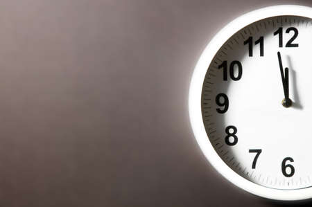 Round clock isolated on black gray background. Minimal concept. Flat lay. Top view. Clock in flat...