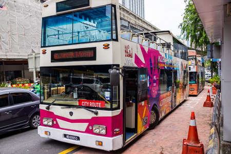 Kuala Lumpur, Malaysia - October 04, 2020: Empty double deck sightseeing buses on the streets of...