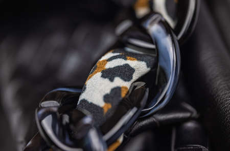 Close up of the chain of a ladies handbag. Leather bag with black textured string. Fashion concept  Luxury leather woman's handbag. black cord of a fashionable black bag. detailed top viewの写真素材