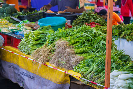 Vegetables on a counter of a vegetable stall in the fresh market. kangkung or water spinach on the...