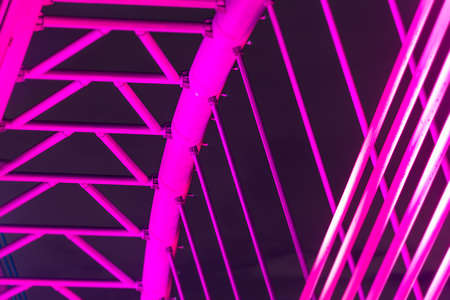 The illuminated structure of the Seri Saujana Bridge at night. One of many bridges in Putrajaya, Malaysia, all alternately illuminated in unison in different colors. Putrajaya Bridge Malaysia at nightのeditorial素材