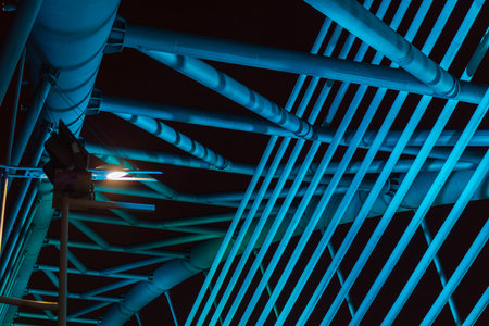 The illuminated structure of the Seri Saujana Bridge at night. One of many bridges in Putrajaya, Malaysia, all alternately illuminated in unison in different colors. Putrajaya Bridge Malaysia at nightのeditorial素材