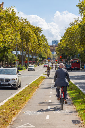 Barcelona, Spain - September 20, 2021: Bicycle lane on avenue Sant Joan. Cityscape with cyclists in the middle lane. Tourist and locals use the bike as fast means of transport through the congested cityのeditorial素材