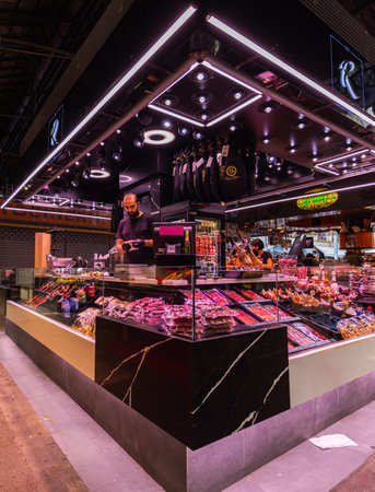 Barcelona, Spain - September 23, 2021: Inside the Mercat de la Boqueria or simply La Boqueria, large public market at La Rambla, Barcelona. Butcher stall with big variety of ham, salami and baconのeditorial素材