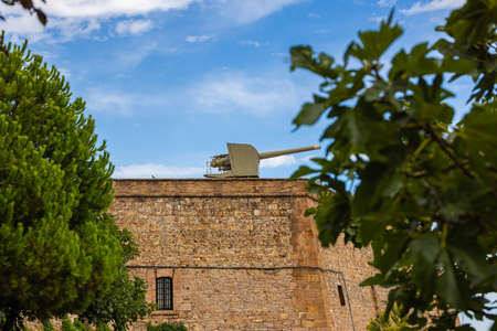 Barcelona, Spain - September 21, 2021: The Castell de Montjuic, a cannon on the wall. Height...