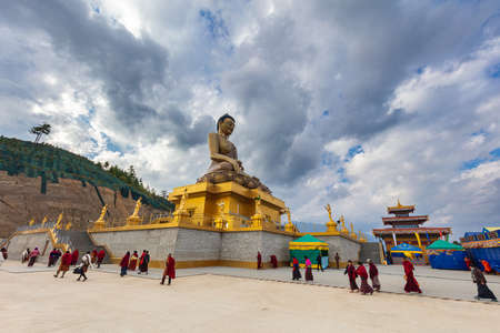 Thimphu, Bhutan - October 25, 2021: Buddha Dordenma statue on the hills around Thimphu. Gigantic golden Shakyamuni Buddha statue in the mountain of Bhutan overlooking the valley. Monks walking aroundのeditorial素材