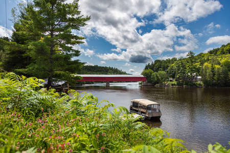 Wakefield, Quebec, Canada - August 30, 2021: Wakefield Covered Bridge crossing the river Gatineau....