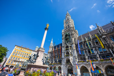 Munich, Germany - July 6, 2022: The new town hall at the Marienplatz, the main square of Munich. Low angle view of the massive gothic revival style building. Many tourists visit the square dailyのeditorial素材