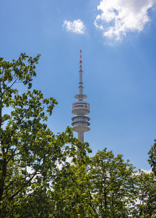 Munich, Germany - July 6, 2022: The Olympiaturm (Olympia tower) at Olympia park. Looking up through...