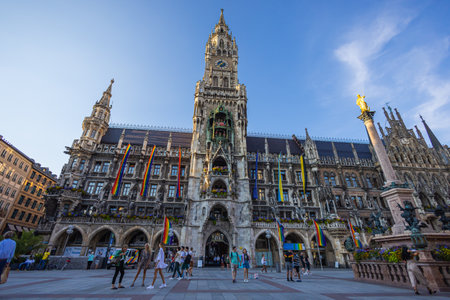 Munich, Germany - July 6, 2022: The new town hall at the Marienplatz, the main square of Munich. Low angle view of the massive gothic revival style building. Many tourists visit the square dailyのeditorial素材