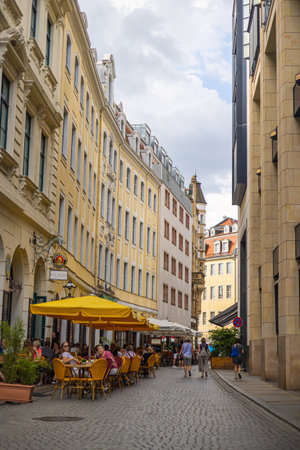Leipzig, Germany - June 25, 2022: View from Thomaskirchhof onto Klostergasse (Monastery alley) with the Paulaner Restaurant. Parasols and tables invite you to linger outside. Historical old townのeditorial素材